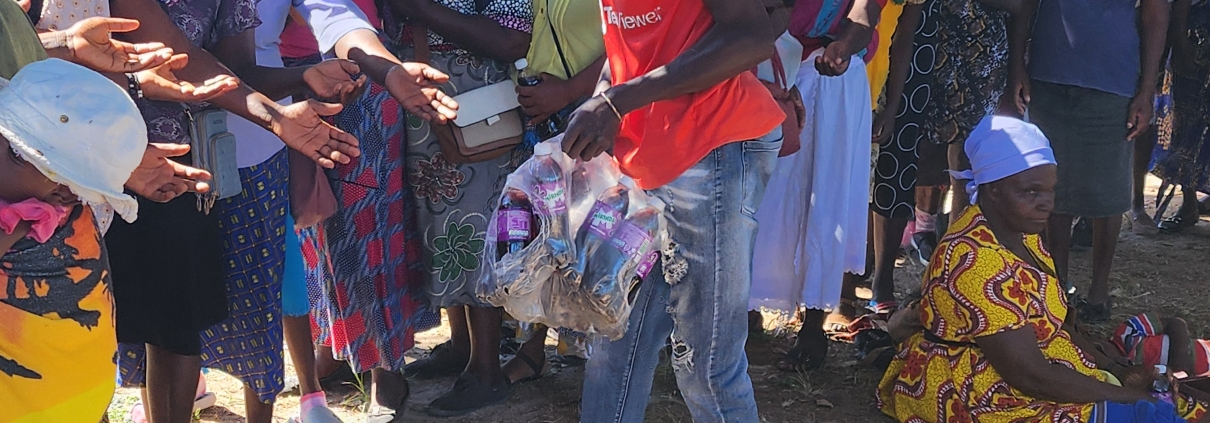 Breaking Barriers volunteers dropping off clothing donation to group of community members in Zimbabwe